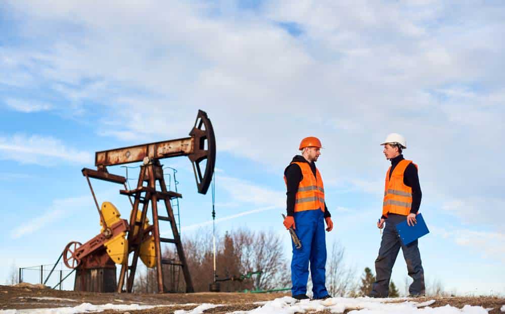 Oil Field Workers Oil Rig in Background