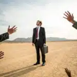 Legal Desert image of an attorney in a desert with hands and arms reaching out to him